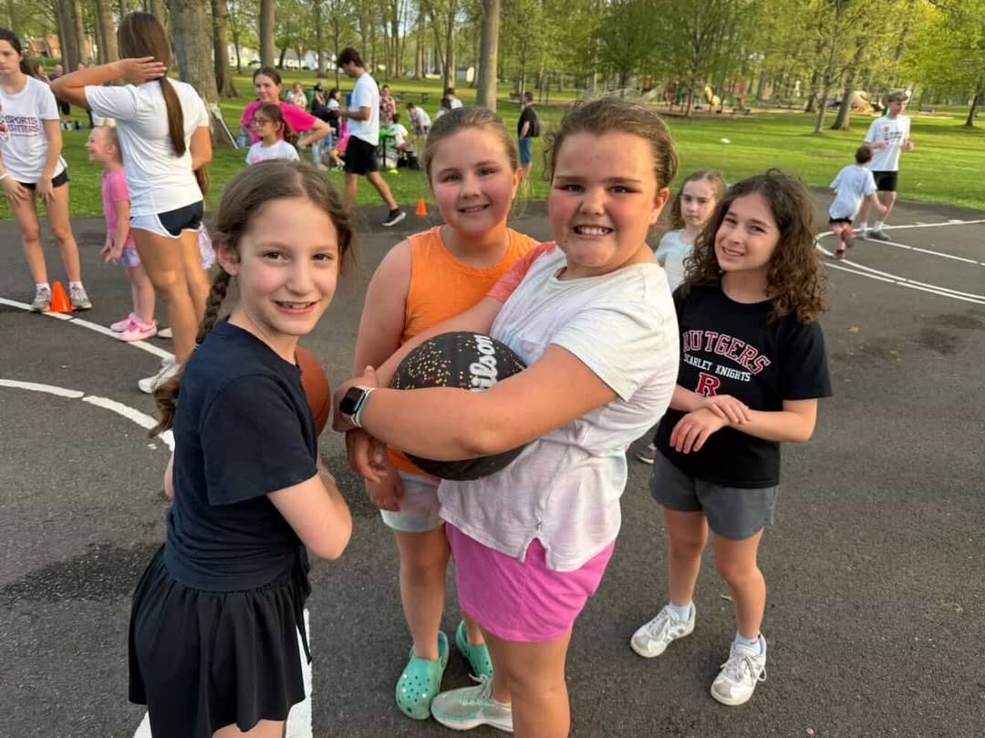 Girls with basketball at Sports Sitters event