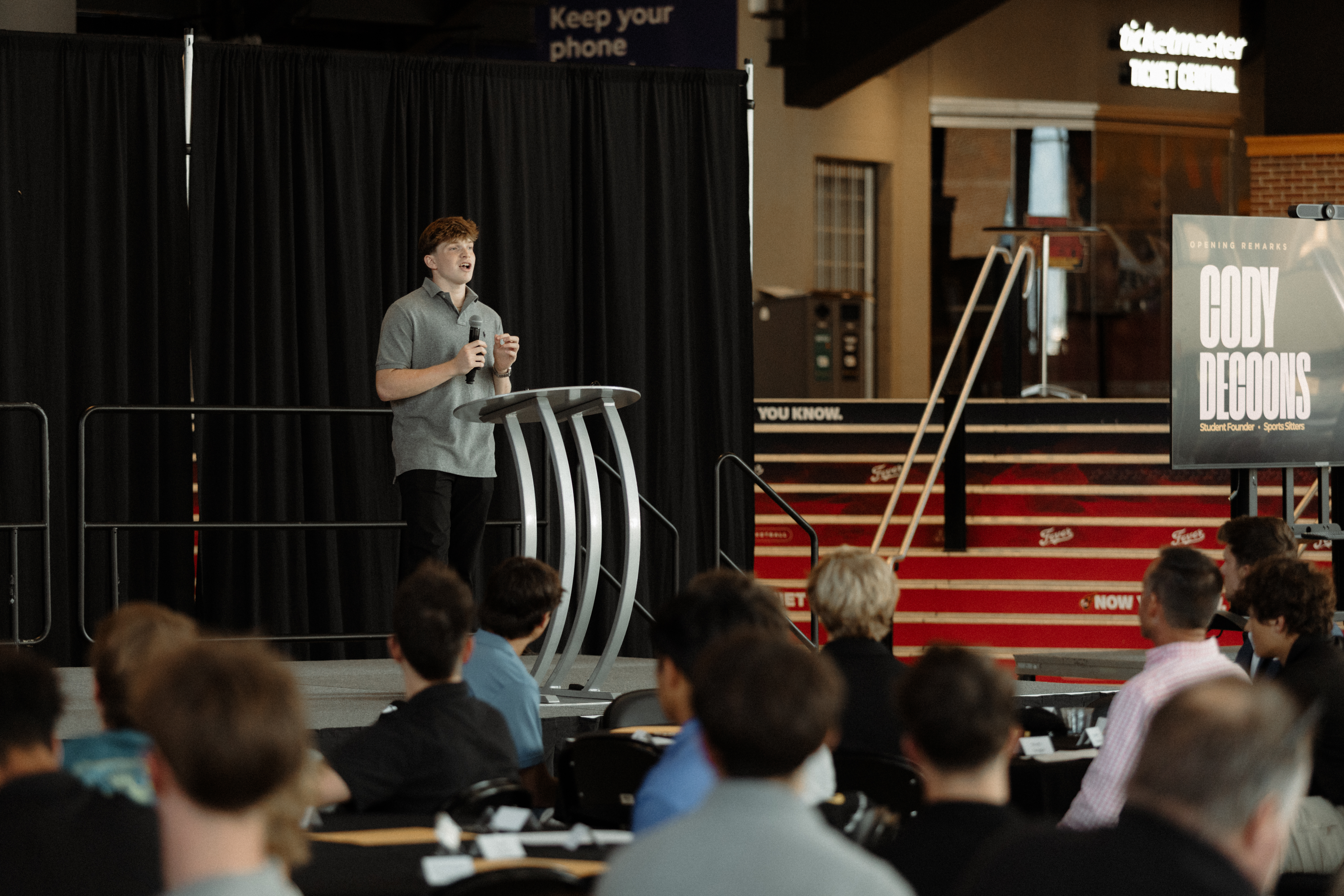 Cody DeCoons giving opening remarks at the High School Hustle Awards Ceremony