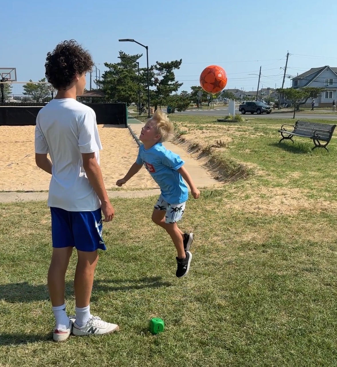 Sports Sitter playing soccer one-on-one at the park