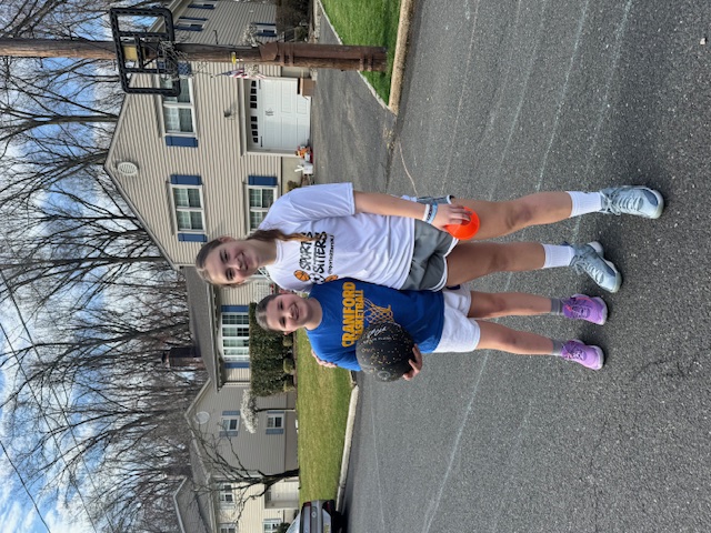 Sports Sitter coaching basketball one-on-one in driveway