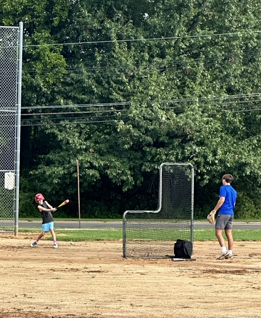 Sports Sitter pitching to a young athlete during a baseball session