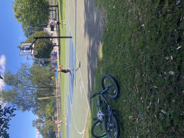 Sports Sitter coaching basketball at the park