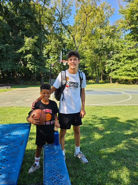Sports Sitter and young athlete with a basketball