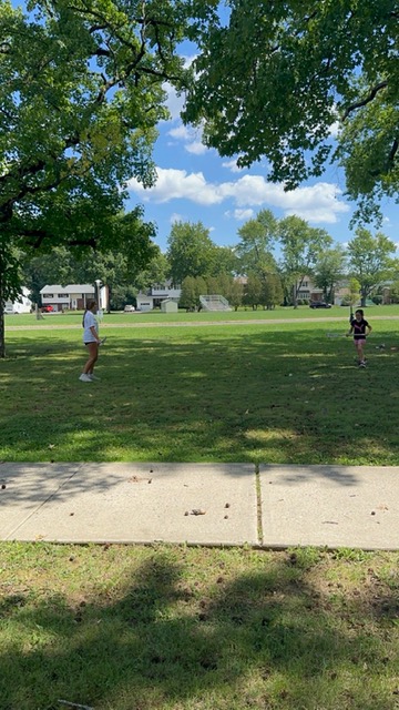 Sports Sitter coaching soccer at the park